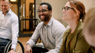 Image of two people interacting in an office environment